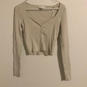 Cream button up low cut shirt.